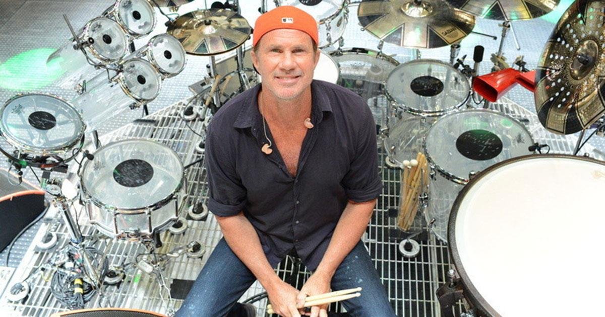 Chad Smith poses for a shot amidst instruments