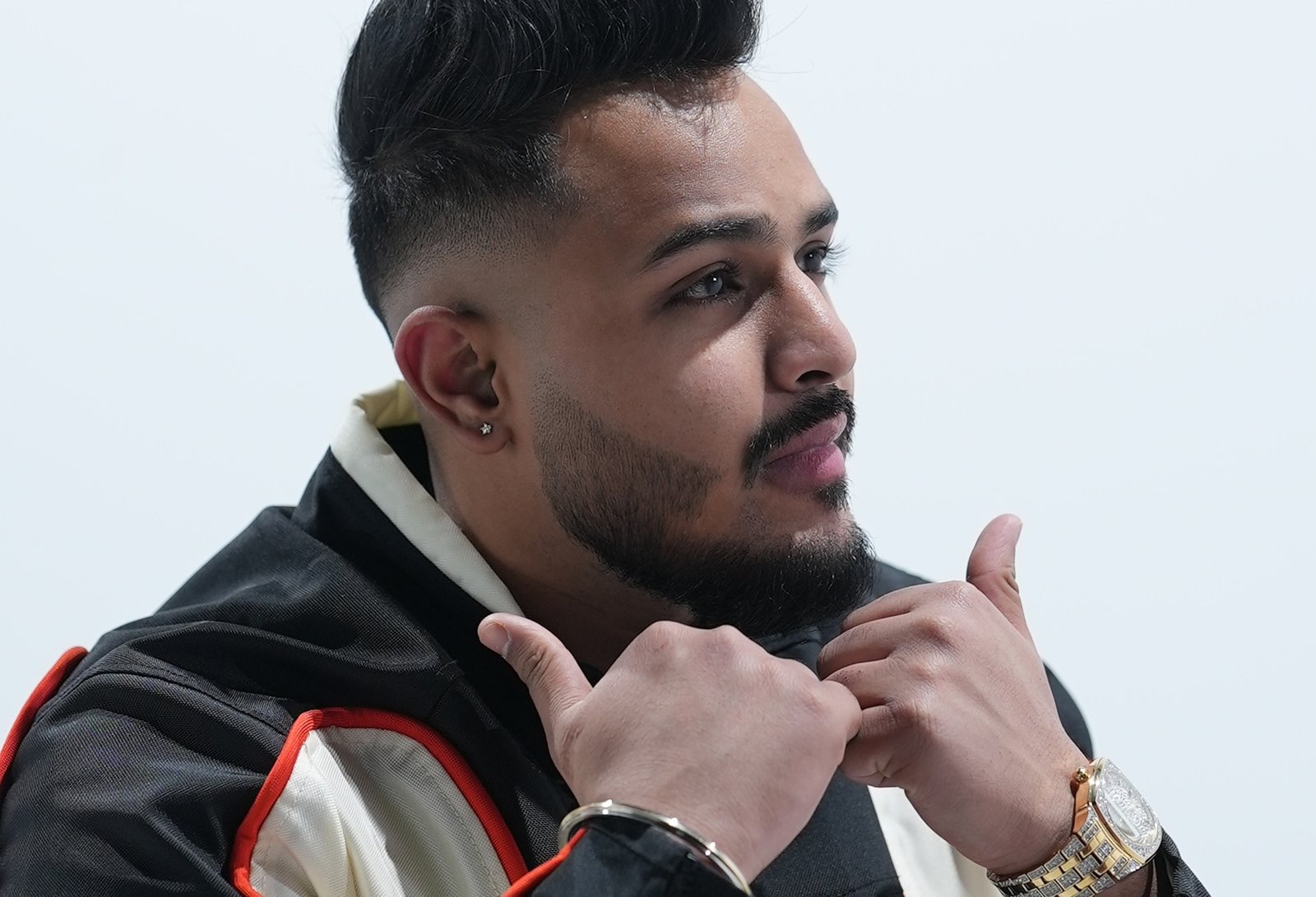 Cheema Y poses for pictures in his designer clothe